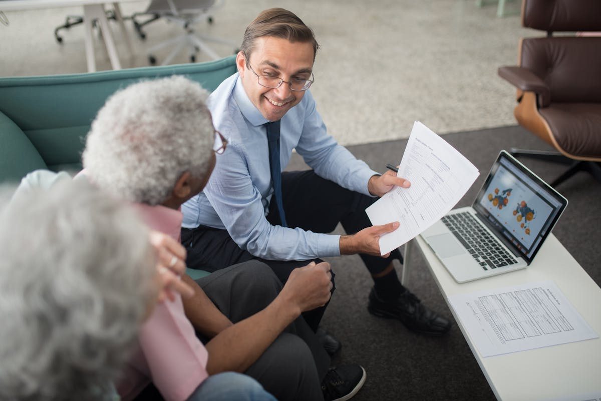 Senior couple meeting with financial advisor about guaranteed retirement income