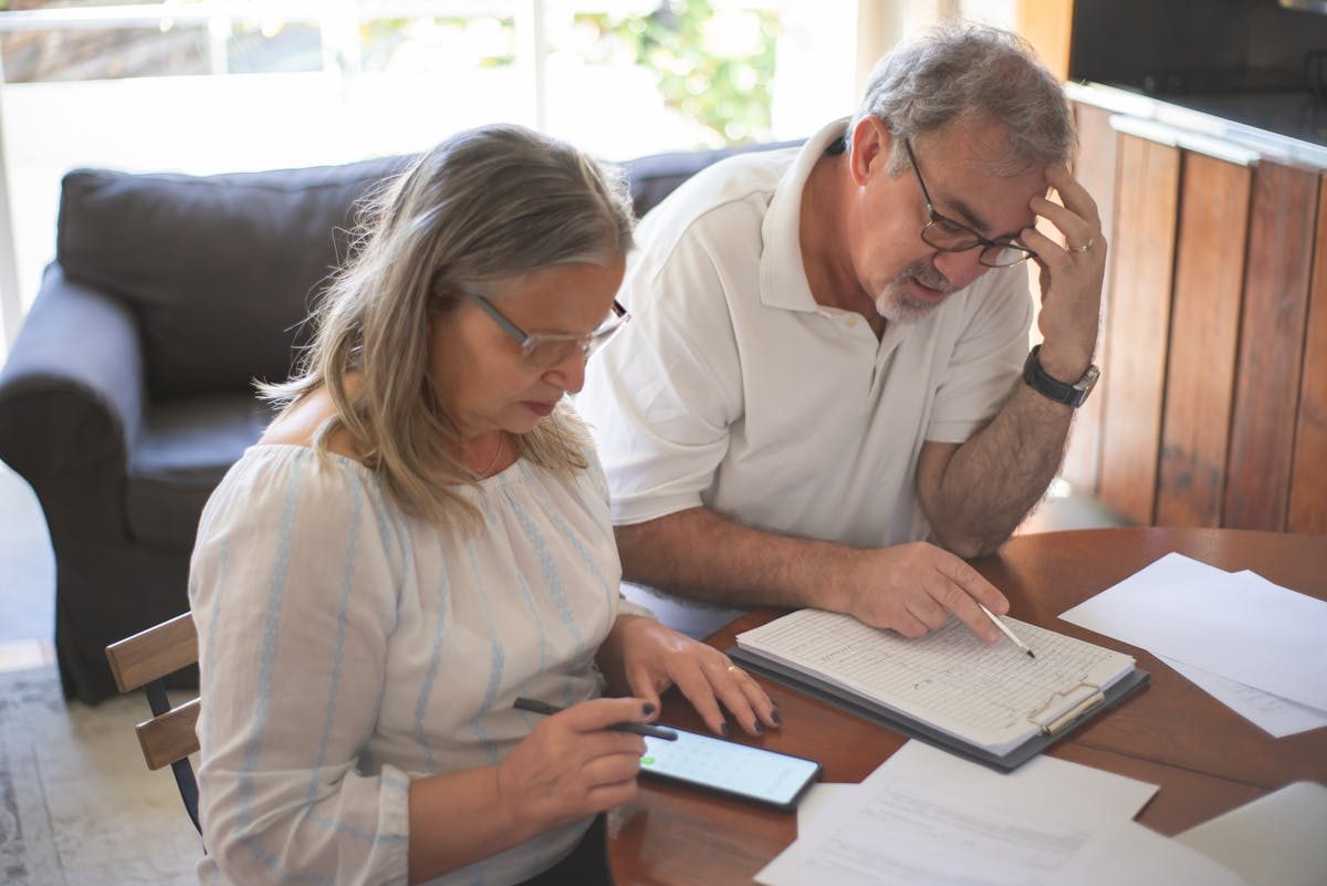 Mature couple reviewing retirement income options at home